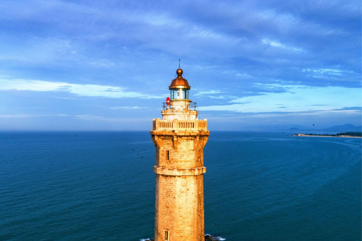 Close-up view of Ke Ga Lighthouse's granite architecture with spiral staircase visible through an opening